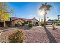 Charming single-story home features a tile roof, arched windows, and a beautifully xeriscaped front yard with mature landscaping at 315 W Sonoma Dr, Litchfield Park, AZ 85340