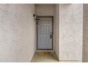 Covered entryway featuring a contemporary door and a friendly 'hello' welcome mat at 342 E Backman St, San Tan Valley, AZ 85140