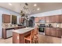 Well-lit kitchen featuring stainless steel appliances, ample counter space, and a convenient pot rack at 38274 N Tumbleweed Ln, San Tan Valley, AZ 85140