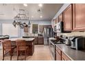 Spacious kitchen featuring stainless steel appliances, wooden cabinets, and a center island with seating at 38274 N Tumbleweed Ln, San Tan Valley, AZ 85140