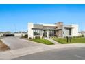 Striking modern home with manicured lawn, stylish entryway, and a neutral color palette at 3964 E Penedes Dr, Gilbert, AZ 85298