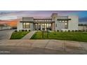 Modern home exterior showcases clean lines, mixed materials, manicured landscaping, and a stone accent at 3964 E Penedes Dr, Gilbert, AZ 85298