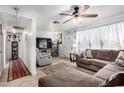 Inviting living room featuring tile floors, a ceiling fan, and a comfortable sofa set for relaxation at 4202 N 74Th Dr, Phoenix, AZ 85033