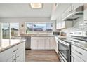 Bright kitchen with stainless appliances, white cabinets and sleek granite countertops provides ample workspace at 4229 W Aster Dr, Phoenix, AZ 85029