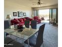 Living room view including a large, comfortable sofa and glass-topped dining table at 425 S Parkcrest -- # 323, Mesa, AZ 85206