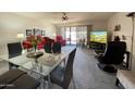 Comfortable living room with a glass dining table, plush red seating, and a sliding door to the outside at 425 S Parkcrest -- # 323, Mesa, AZ 85206