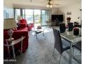 Open concept living room with sliding glass doors to the balcony with lovely outdoor views at 425 S Parkcrest -- # 323, Mesa, AZ 85206