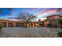 Sprawling estate showcasing a circular driveway, multi-car garage, and lush desert landscaping for enhanced curb appeal at 42613 N 111Th Pl, Scottsdale, AZ 85262