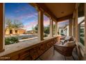 Relaxing front porch with stone accents and comfortable seating at 4820 N 210Th Ave, Buckeye, AZ 85396