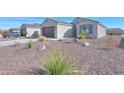 Attractive single-story house featuring low-maintenance landscaping, a garage, and a cozy front porch at 5091 N Bryce Canyon Dr, Eloy, AZ 85131