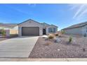 Inviting single-story home with desert landscaping, a two-car garage, and a covered entryway at 5091 N Bryce Canyon Dr, Eloy, AZ 85131