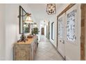 Elegant foyer with a decorative mirror, unique lighting fixtures, and a stylish console table, setting a sophisticated tone at 6611 E Peak View Rd, Cave Creek, AZ 85331