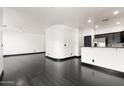 Spacious living room featuring modern black floors and neutral walls at 7601 E Roosevelt St # 1007, Scottsdale, AZ 85257