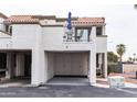 Charming condo with a private balcony, complete with seating and shade provided by a bright blue umbrella at 7755 E Thomas Rd # 8, Scottsdale, AZ 85251