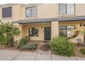 Charming townhome exterior with neat landscaping, and a covered entryway, providing a welcoming facade at 7801 N 44Th Dr # 1059, Glendale, AZ 85301