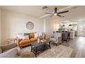 Stylish living room with a comfortable brown sofa, ceiling fan, and an open layout to the kitchen at 7801 N 44Th Dr # 1059, Glendale, AZ 85301