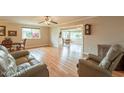 Open-concept living room featuring wood floors and abundant natural light at 9402 N 109Th Dr, Sun City, AZ 85351