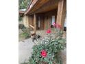 Inviting front porch with beautiful roses and a brick walkway leading to a cozy wood clad entrance at 9620 S 156Th Pl, Gilbert, AZ 85234