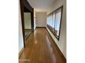 Bright hallway featuring beautiful hardwood floors, elegant windows, and a serene, welcoming atmosphere at 9620 S 156Th Pl, Gilbert, AZ 85234