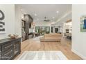 Open-concept living room with hardwood floors and fireplace at 9781 E Gamble Ln, Scottsdale, AZ 85262