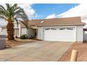 Single-story home with a two-car garage and desert landscaping at 10216 W Minnezona Ave, Phoenix, AZ 85037