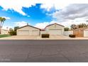 Detached garages with white walls and red tile roofs provide ample parking space at 109 W Kathleen Rd, Phoenix, AZ 85023