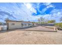 A spacious backyard featuring desert landscaping, block walls, and plenty of room for outdoor activities at 11388 N 114Th Dr, Youngtown, AZ 85363