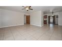 Spacious living room featuring tile flooring, ceiling fan, and a large window that provides natural light at 11388 N 114Th Dr, Youngtown, AZ 85363