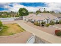 Long driveway leads to a meticulously kept residence, highlighted by mature trees, rock landscaping, and private fencing at 1349 E Anasazi St, Mesa, AZ 85203