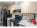 Kitchen with black appliances, white countertops, and white cabinets at 13842 N 109Th Ave, Sun City, AZ 85351