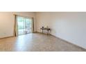 Bright living room featuring tile flooring and a sliding glass door at 13842 N 109Th Ave, Sun City, AZ 85351