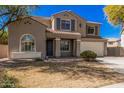 Charming two-story home featuring a well-manicured lawn and an attached two-car garage at 1481 E Lark St, Gilbert, AZ 85297