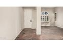 Bright foyer showcasing tile flooring, arched window and a white front door at 1481 E Lark St, Gilbert, AZ 85297