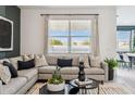 Cozy living room featuring a comfortable sectional sofa, decorative pillows, and a view of the outdoors at 1503 S 239Th Dr, Buckeye, AZ 85326