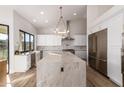 Spacious kitchen with white cabinetry, a large island, stainless steel appliances, and modern lighting at 15747 E Greystone Dr, Fountain Hills, AZ 85268