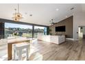 Open-concept living and dining area with large windows offering scenic views and contemporary design at 15747 E Greystone Dr, Fountain Hills, AZ 85268