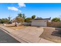 Exterior showcasing the house, driveway, and a well-kept lawn with mature trees at 1743 N Dresden --, Mesa, AZ 85203