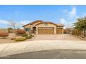 Charming single-story home with a three-car garage, desert landscaping, and a paver driveway at 17530 W Oberlin Way, Surprise, AZ 85387