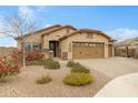 Welcoming single-story home featuring desert landscaping and a spacious three-car garage at 17530 W Oberlin Way, Surprise, AZ 85387