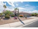 Well-maintained home with mature palm trees, desert landscaping, and a spacious three car garage at 18701 N Diamond Dr, Surprise, AZ 85374