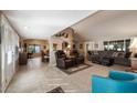 Open-concept living room with tile and carpet flooring, comfortable seating, and abundant natural light at 1873 Leisure World --, Mesa, AZ 85206