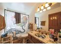 Bathroom featuring an elephant-themed shower curtain, tiled vanity, and decorative mirror at 1908 E Beck Ln, Phoenix, AZ 85022