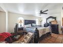 Bedroom with a dark wood bed set and small arched windows for natural light at 1908 E Beck Ln, Phoenix, AZ 85022