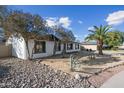 Attractive single-story home with desert landscaping, a palm tree, and rock accents at 1911 W Kimberly Way, Phoenix, AZ 85027