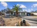 Inviting single-story home featuring desert landscaping, palm tree and a long driveway at 1911 W Kimberly Way, Phoenix, AZ 85027