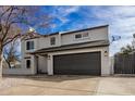 Two-story home boasts well-manicured gravel yard and a spacious driveway, providing ample parking at 19409 N 45Th Dr, Glendale, AZ 85308