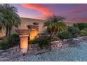 Relaxing outdoor area with a stone water feature and lush, mature plants at 20639 N 123Rd Dr, Sun City West, AZ 85375