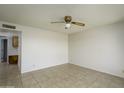 Bright living room features neutral walls, tile flooring, and a classic ceiling fan at 2064 S Farnsworth Dr # 43, Mesa, AZ 85209