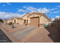 Inviting exterior featuring desert landscaping, a two-car garage, and a well-kept driveway at 2101 S Meridian Rd # 176, Apache Junction, AZ 85120