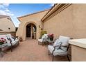 Inviting front patio with comfortable seating and a charming entrance to the home at 22524 N San Ramon Dr, Sun City West, AZ 85375